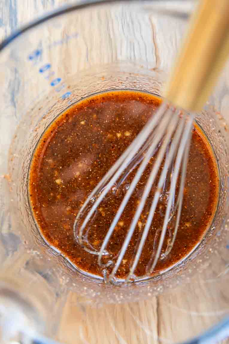 Honey buffalo sauce whisked in a bowl.