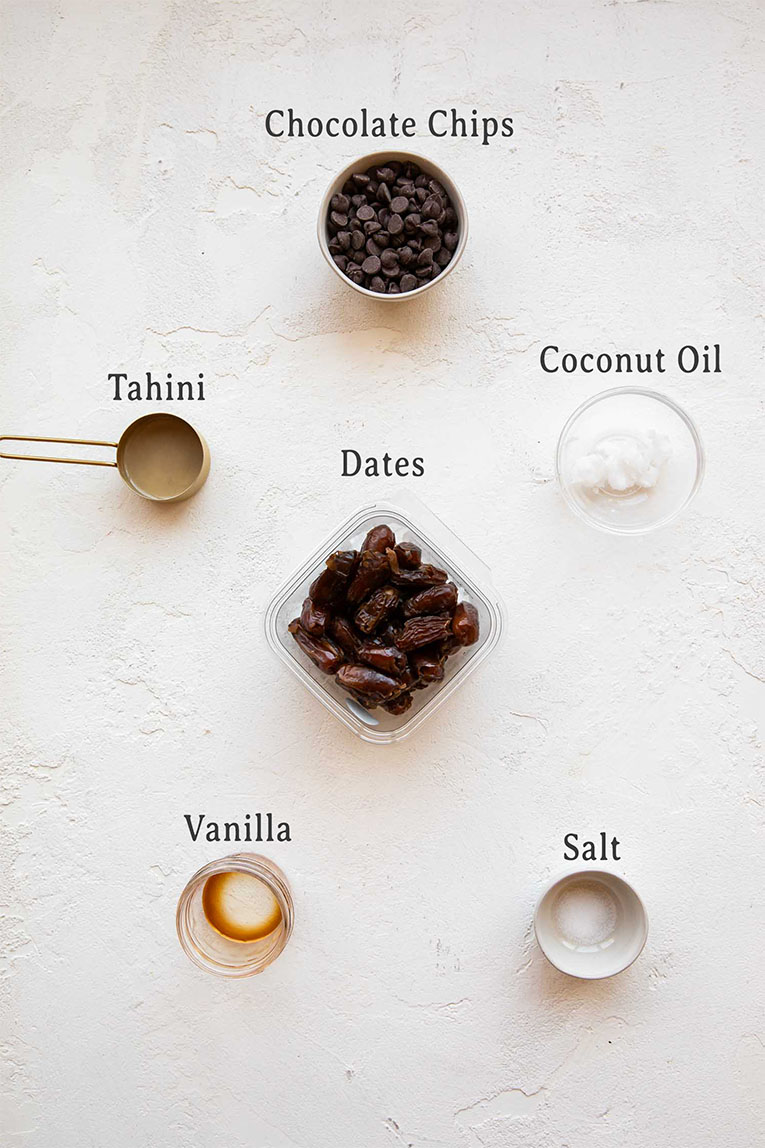 Healthy Tahini Salted Caramel Truffles ingredients on a white board.