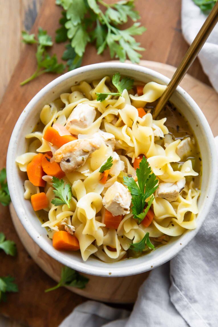 Chicken Noodle Soup easy recipe in a bowl with a spoon.