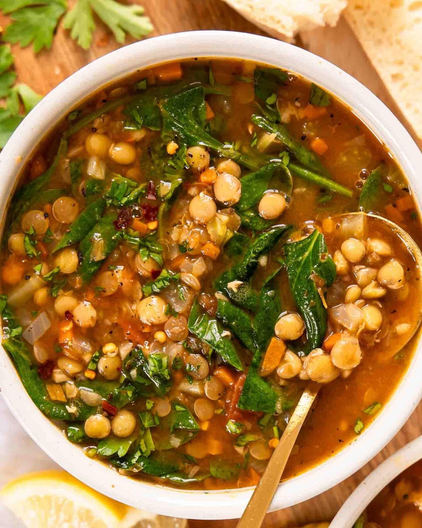 Top photo of vegan lentil soup in a bowl with a spoon.