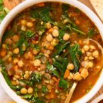 Top photo of vegan lentil soup in a bowl with a spoon.
