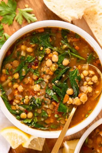 Top photo of vegan lentil soup in a bowl with a spoon.
