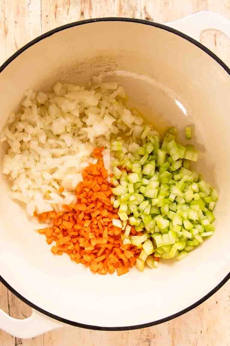 Veggies being sautéed in a Dutch oven.