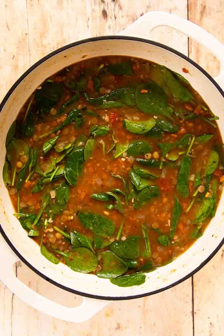 Lentil Soup recipe in a Dutch oven being cooked.