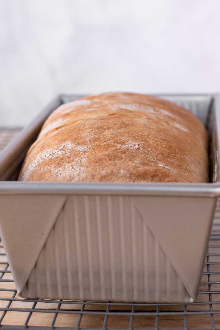 Sandwich bread after baking in a loaf pan.