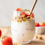 Across photo of Strawberry Cheesecake Breakfast Parfait in a glass.
