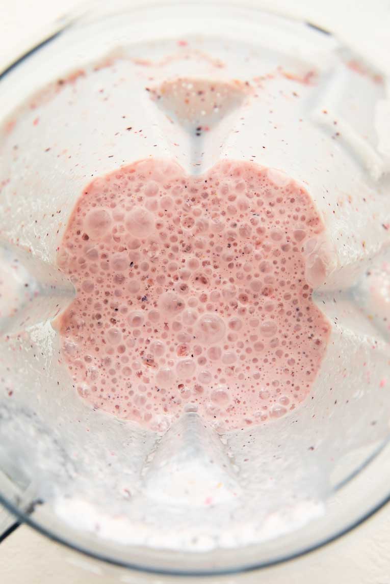 Strawberry milk in a blender.