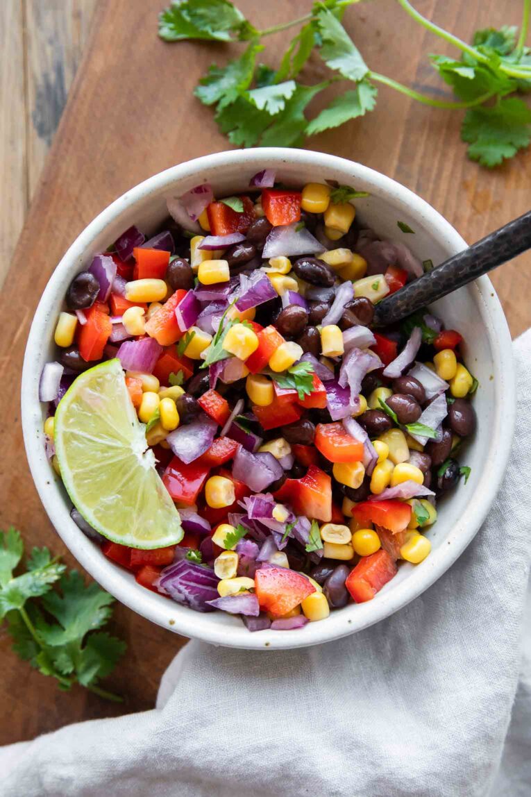 Easy Black Bean Salad recipe in a bowl with lime.