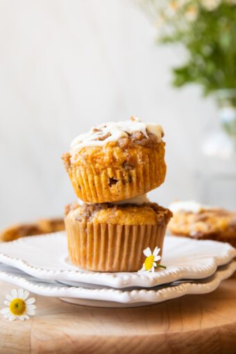 Across photo of stack of Carrot Cake Muffins.