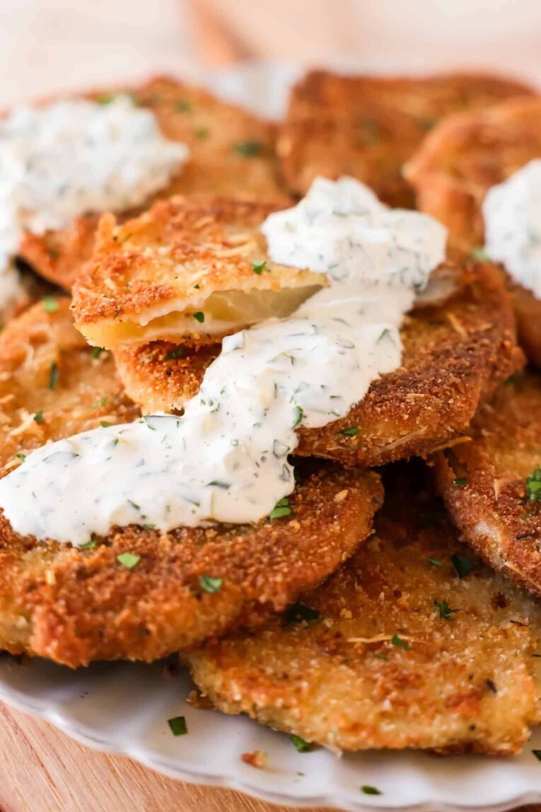 Angled photo of Fried Green Tomatoes with sauce.
