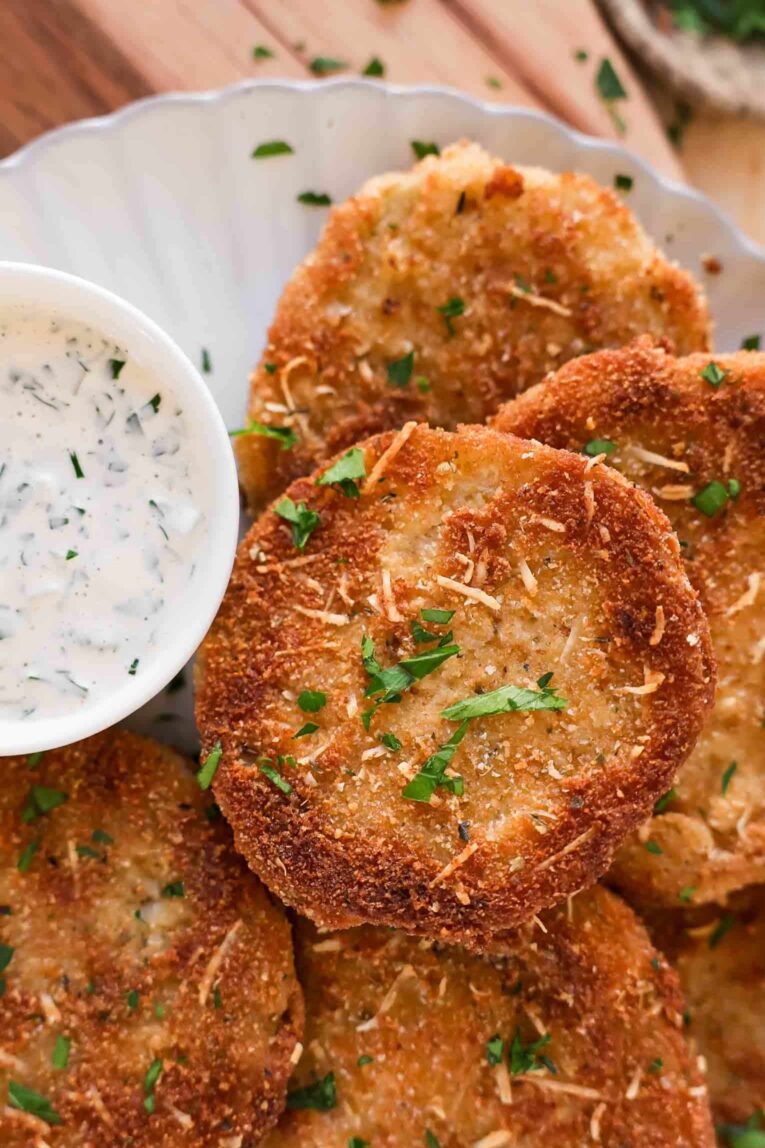 Close up of Fried Green Tomatoes with creamy sauce.