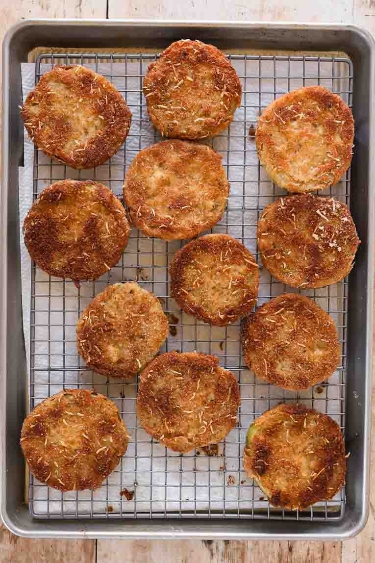 Fried Green Tomatoes cooling on a cooling rack.