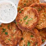 Fried Green Tomatoes on a plate with creamy dipping sauce.