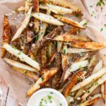 Garlic Truffle Fries recipes on a baking sheet with parchment paper.