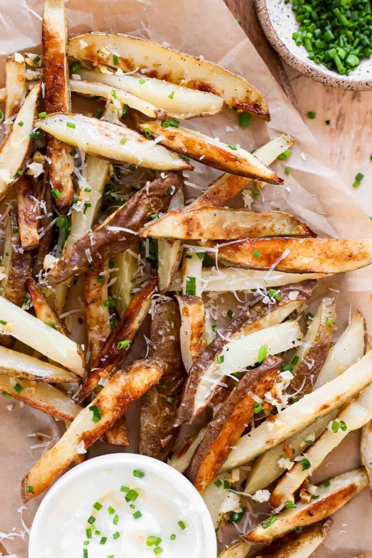 Garlic Truffle Fries on a baking sheet with parchment paper.