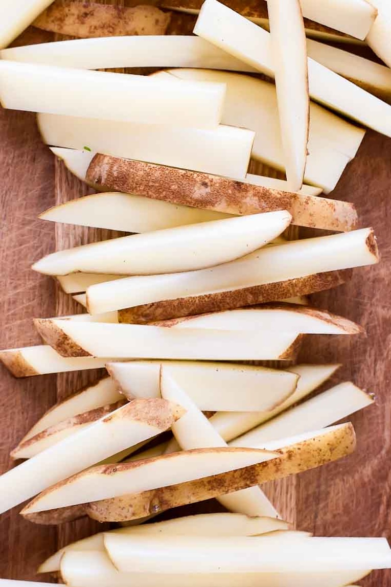 Sliced potatoes on a cutting board.