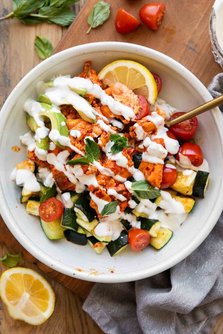 Harissa Salmon Bites Bowl with a fork and sauce.