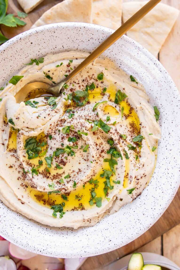 Close up of garlic hummus recipe with olive oil and tahini.