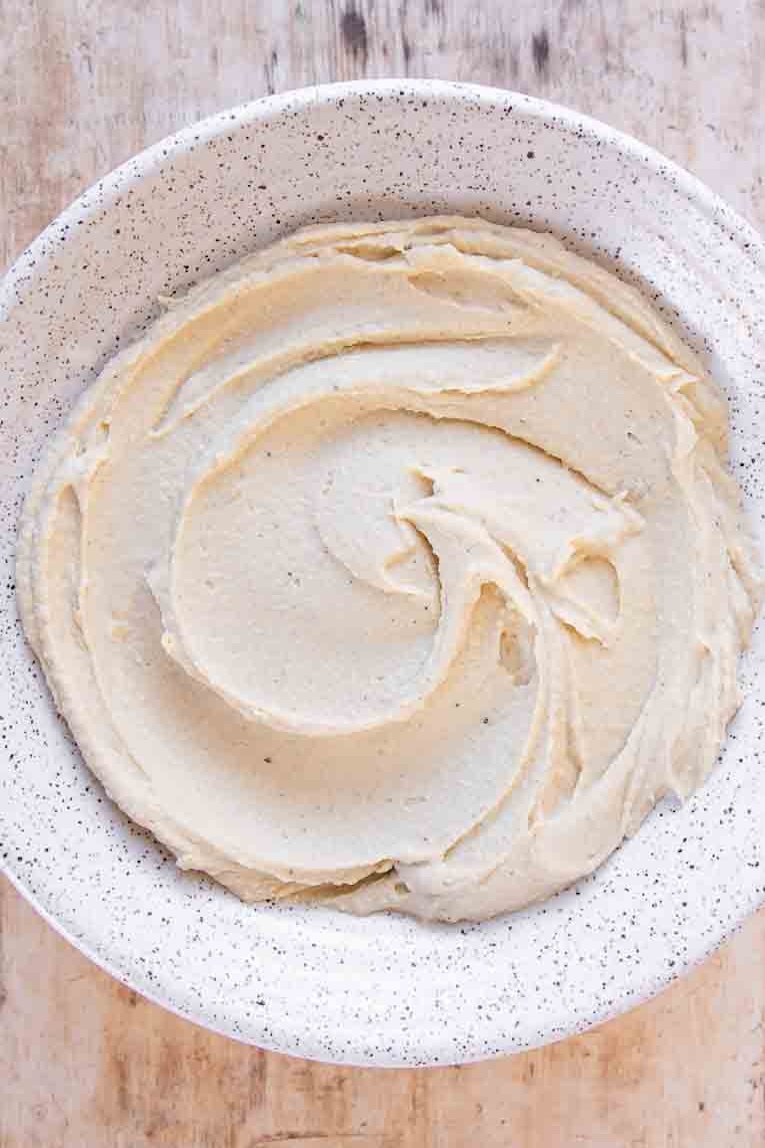 Freshly made easy hummus poured into a bowl.