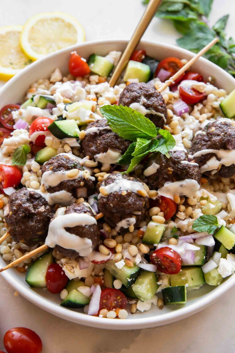 Angled photo of Mediterranean Salad Bowls w/ Lebanese Meatballs.