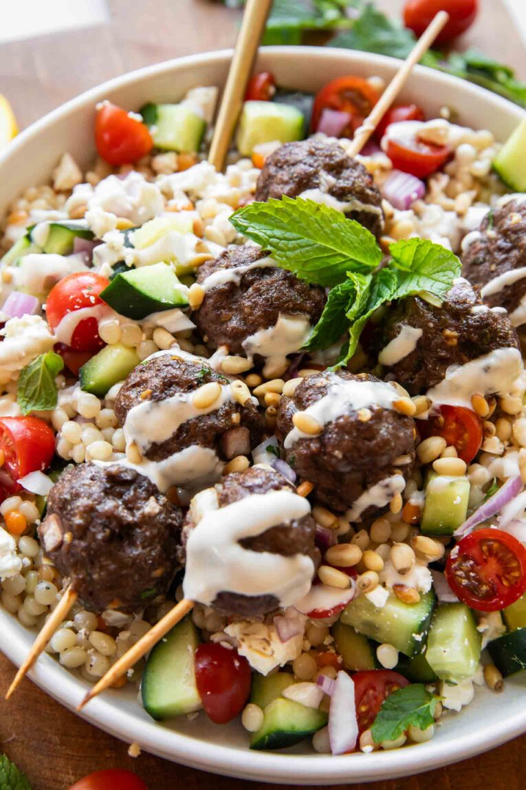 Angled close up of Mediterranean Salad Bowl recipe w/ Lebanese Meatballs.