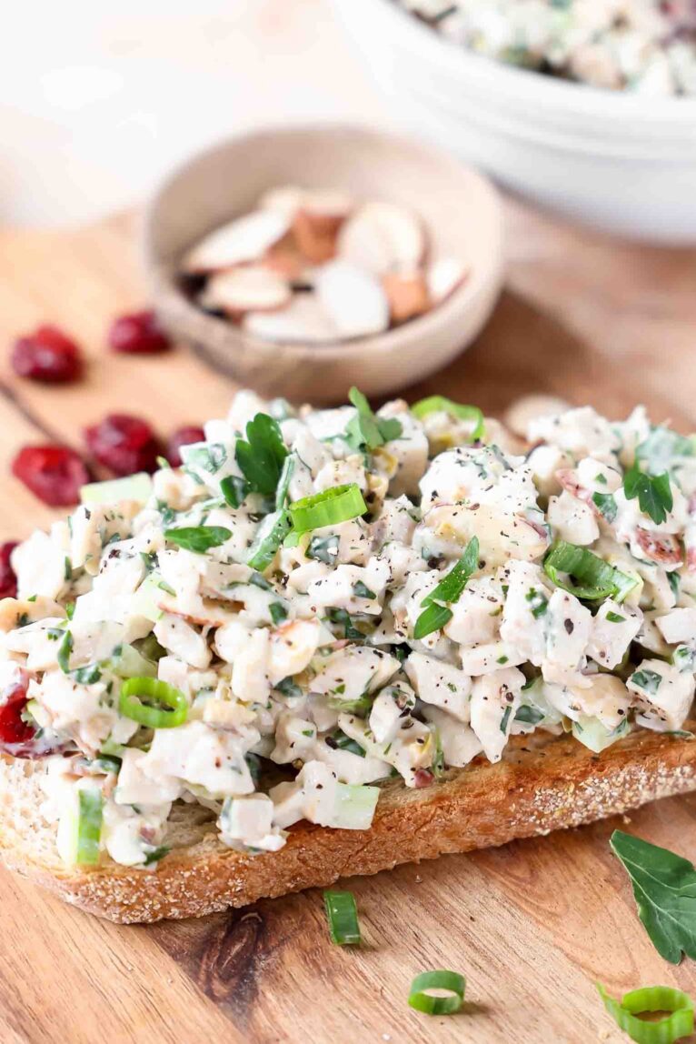 Angled photo of healthy chicken salad on toasted bread.