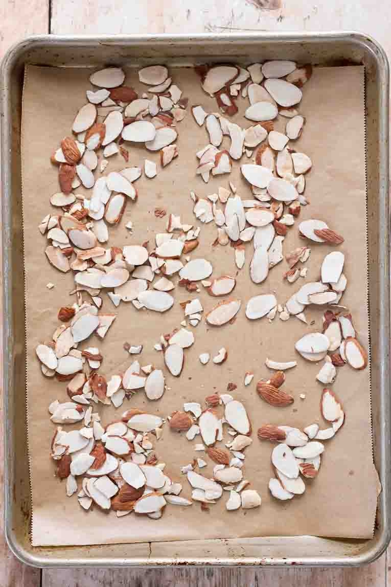 Almonds on a baking sheet being toasted.