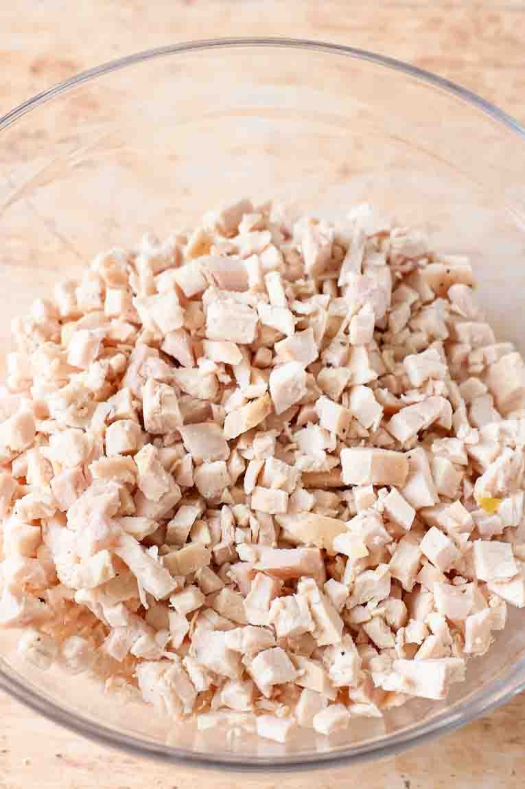 Chicken and almonds in a mixing bowl.