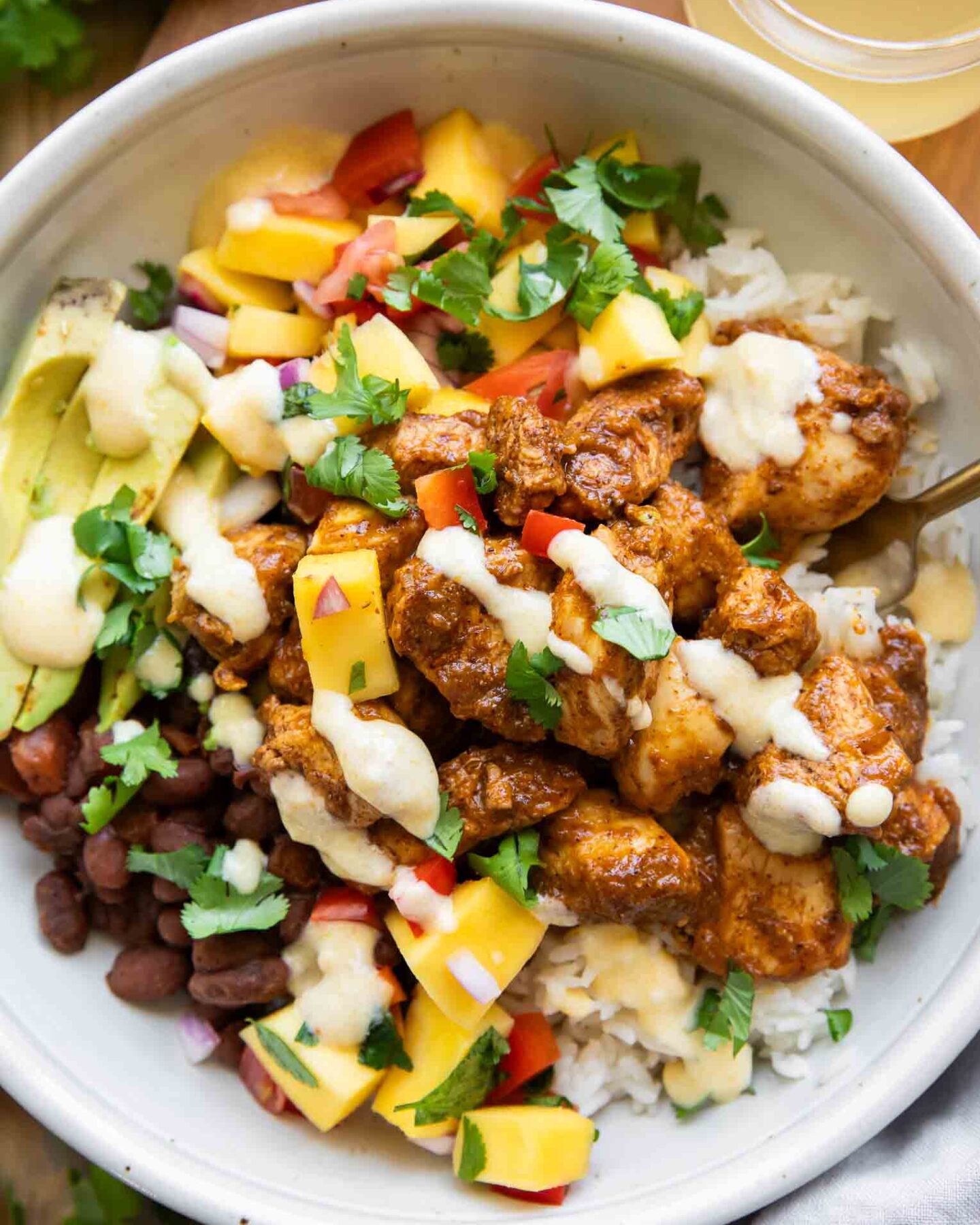 Mango Habanero Chicken Bowls with sauce drizzle.