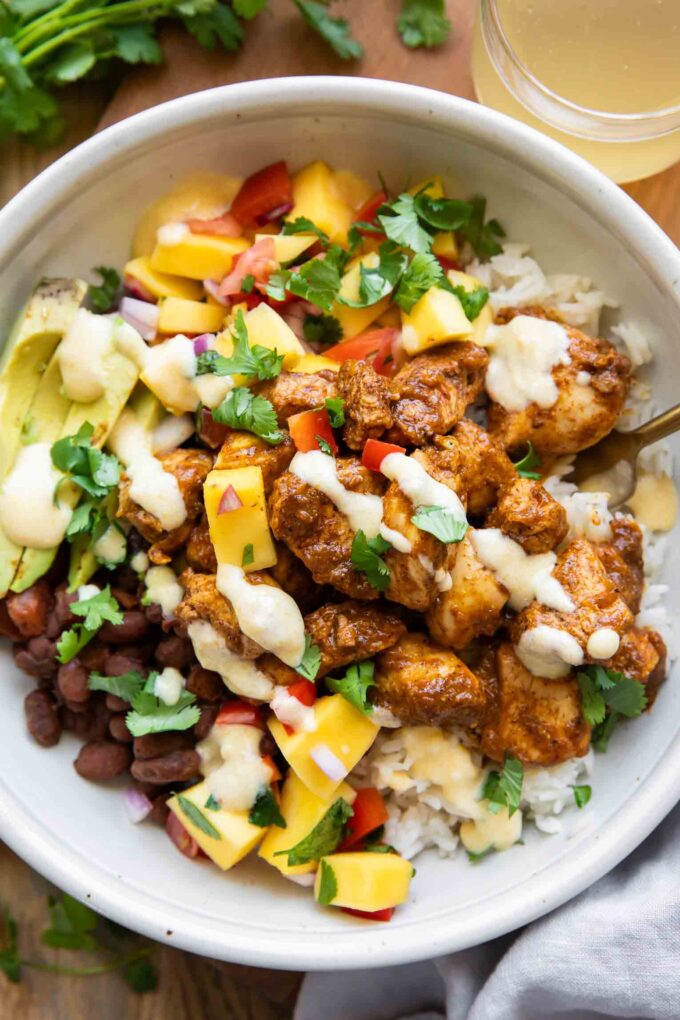 Mango Habanero Chicken Bowls with sauce drizzle.