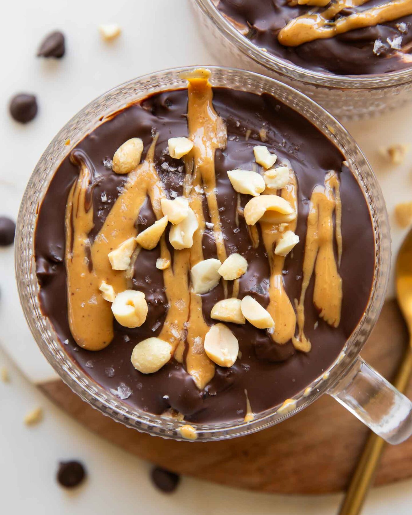 Close up of Snickers Overnight Oats in mug jars.