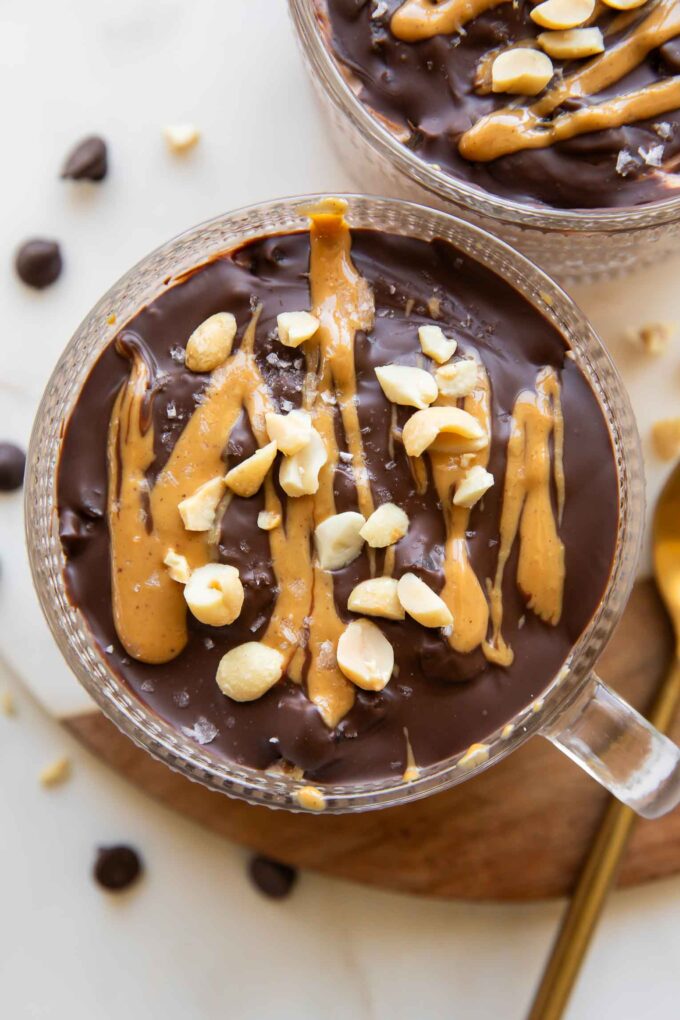 Close up of Snickers Overnight Oats in mug jars.
