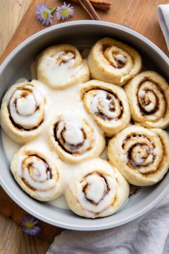 Cottage Cheese Cinnamon Rolls in a pan with glaze.