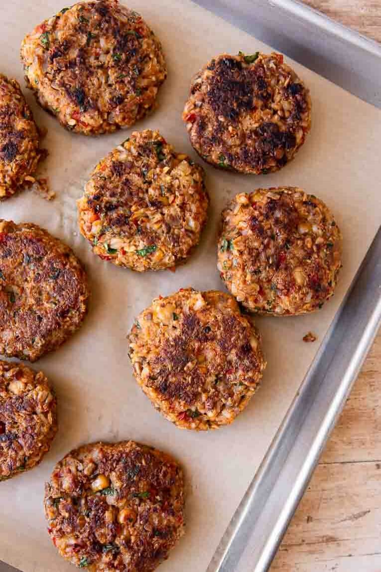Oven baked Veggie Burgers on a baking sheet.