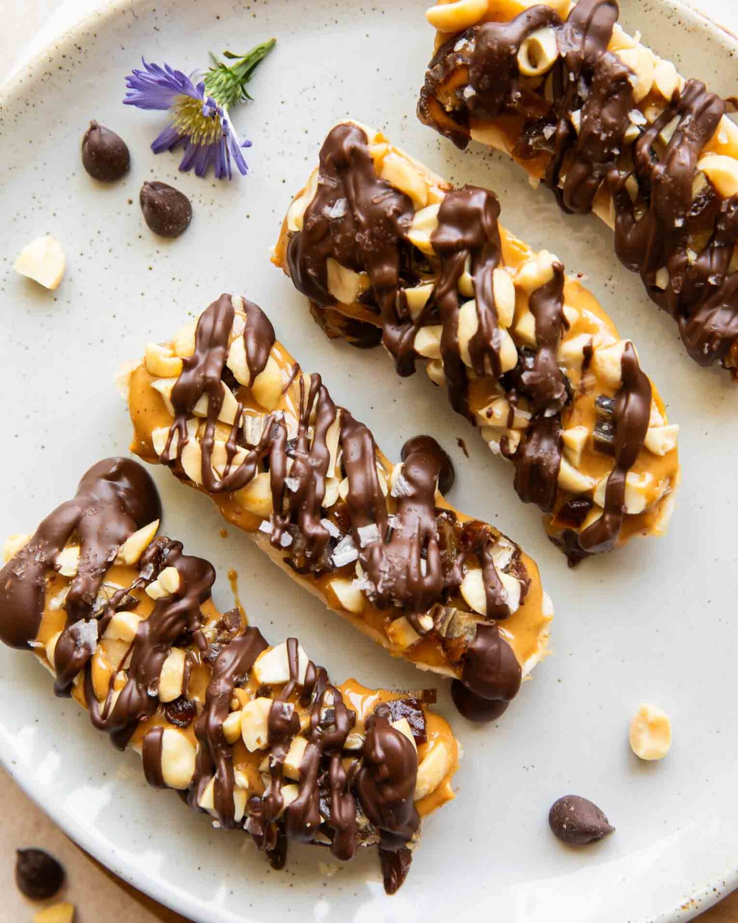 Close up of frozen bananas with snickers toppings.