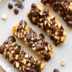 Close up of frozen bananas with snickers toppings.