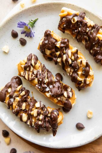 Close up of frozen bananas with snickers toppings.
