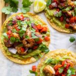 Shrimp Guacamole Tostadas on parchment paper.