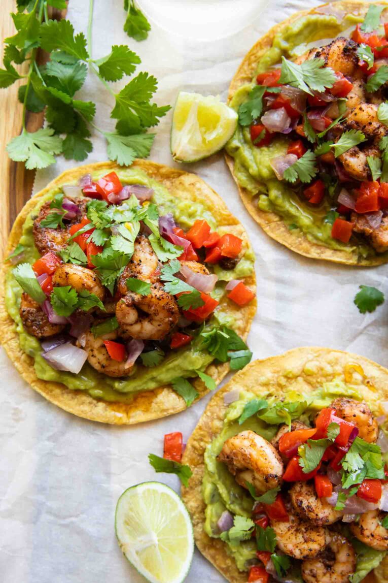 Shrimp Guacamole Tostadas on parchment paper.