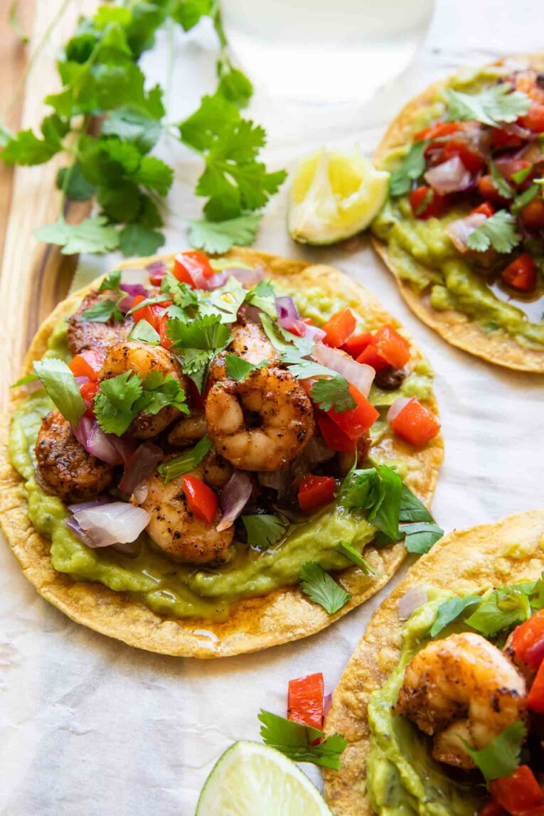Shrimp tostada with guacamole and lime.