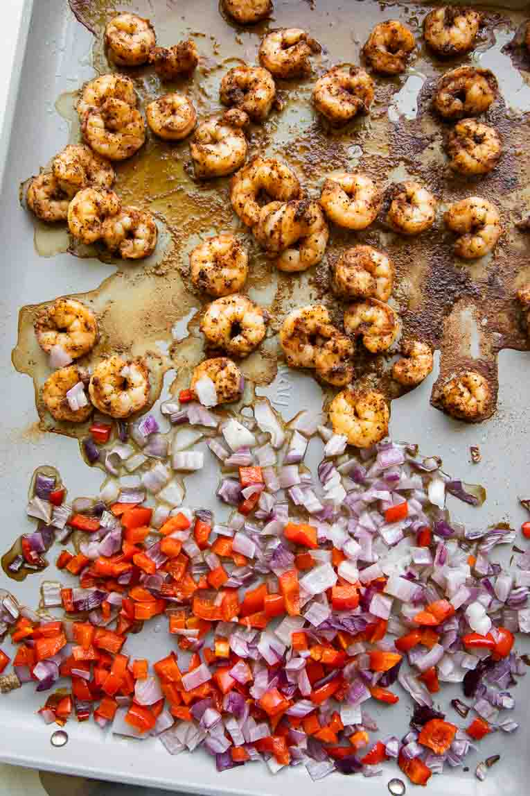 Shrimp and veggies baked on a sheet pan.