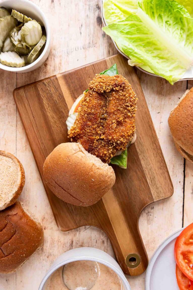 Top shot photo of Spicy Chicken Sandwich on a cutting board with toppings.