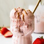 Strawberry Cottage Cheese Ice Cream in a parfait glass with a spoon.