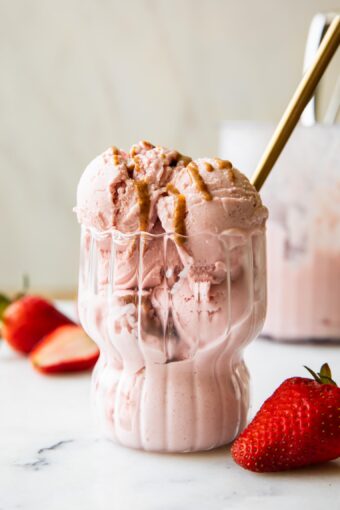 Strawberry Cottage Cheese Ice Cream in a parfait glass with a spoon.