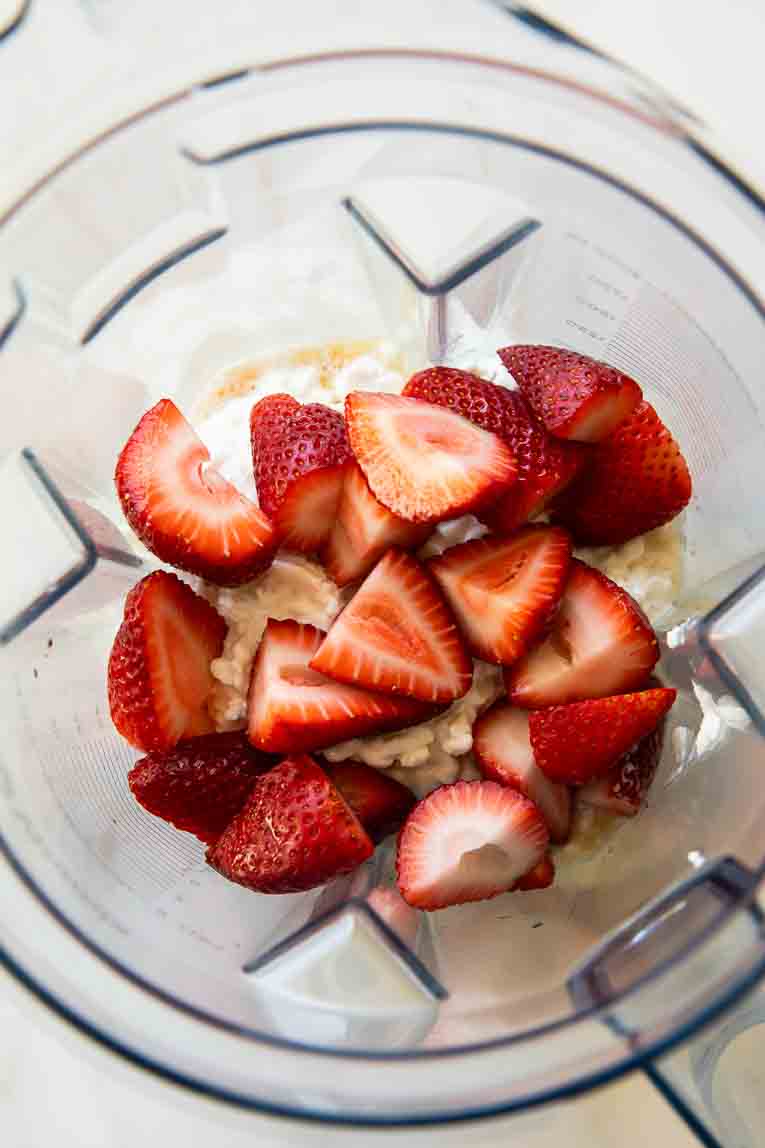 Strawberries and cottage cheese in a blender.