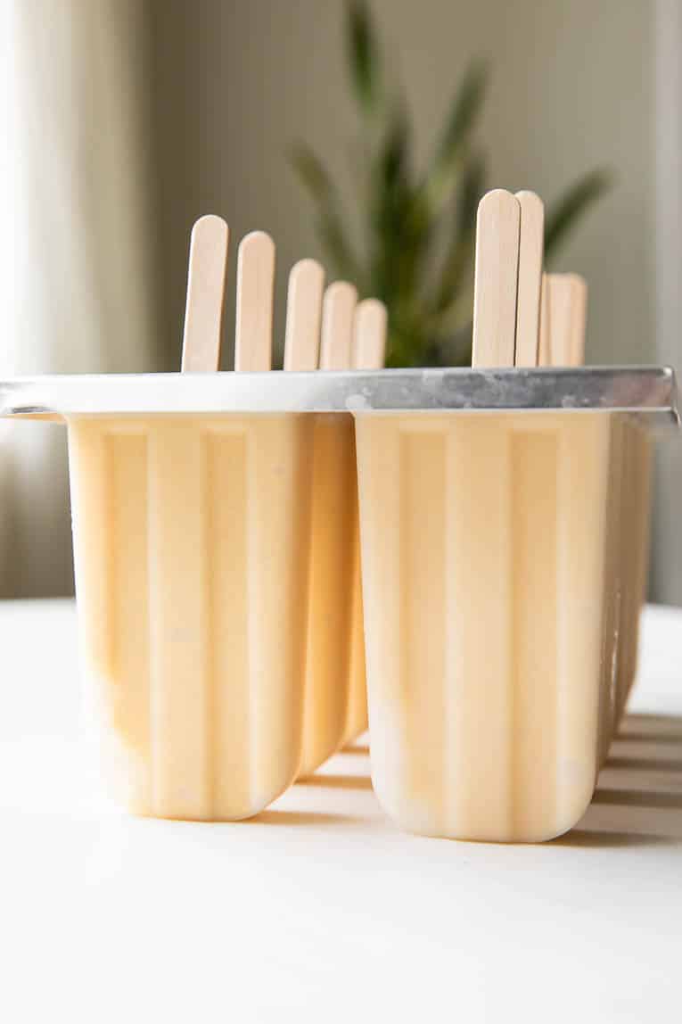 Across photo of frozen Coconut Peach Popsicles.