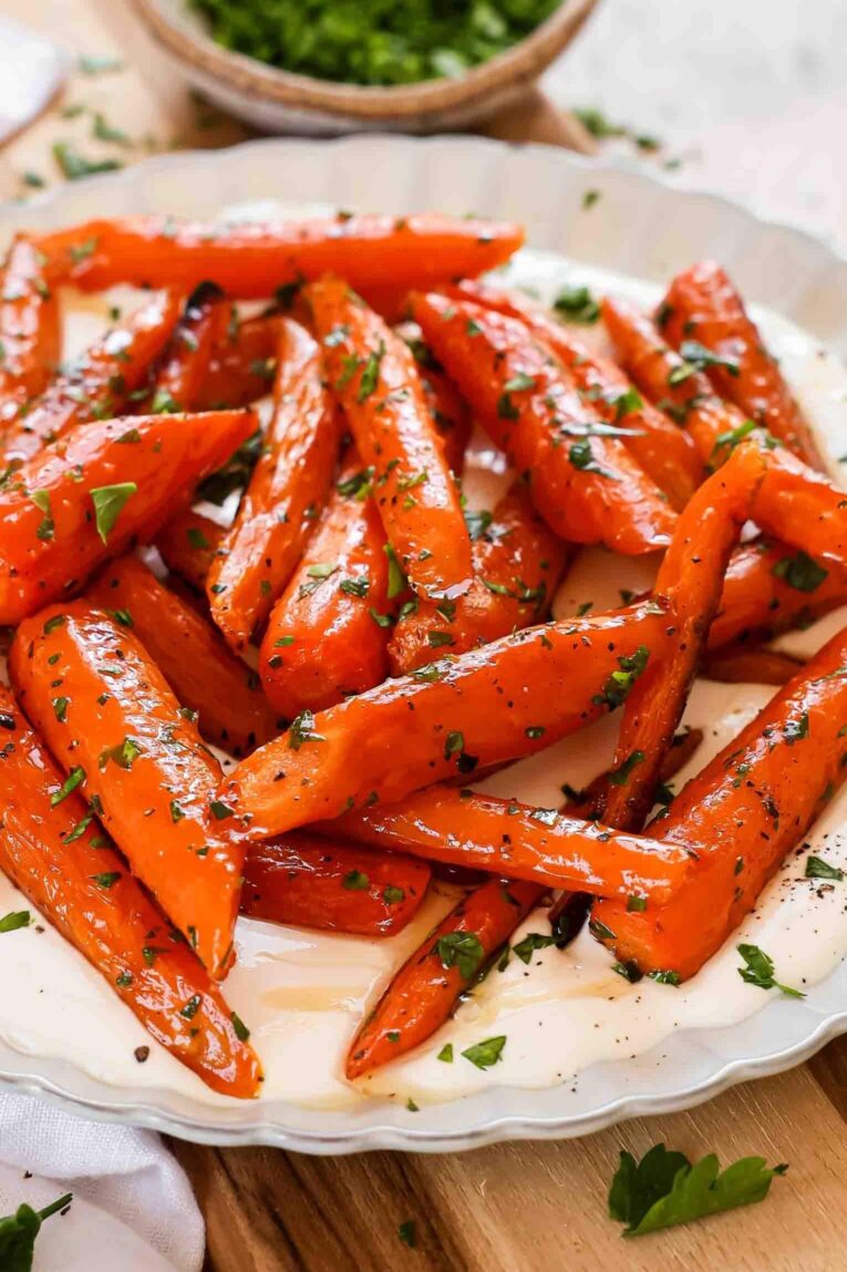 Angled photo of roasted carrots with whipped cottage cheese.