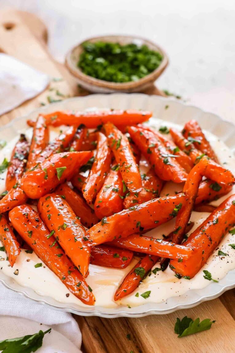 Angled photo of Easy Roasted Carrots recipe over whipped feta.