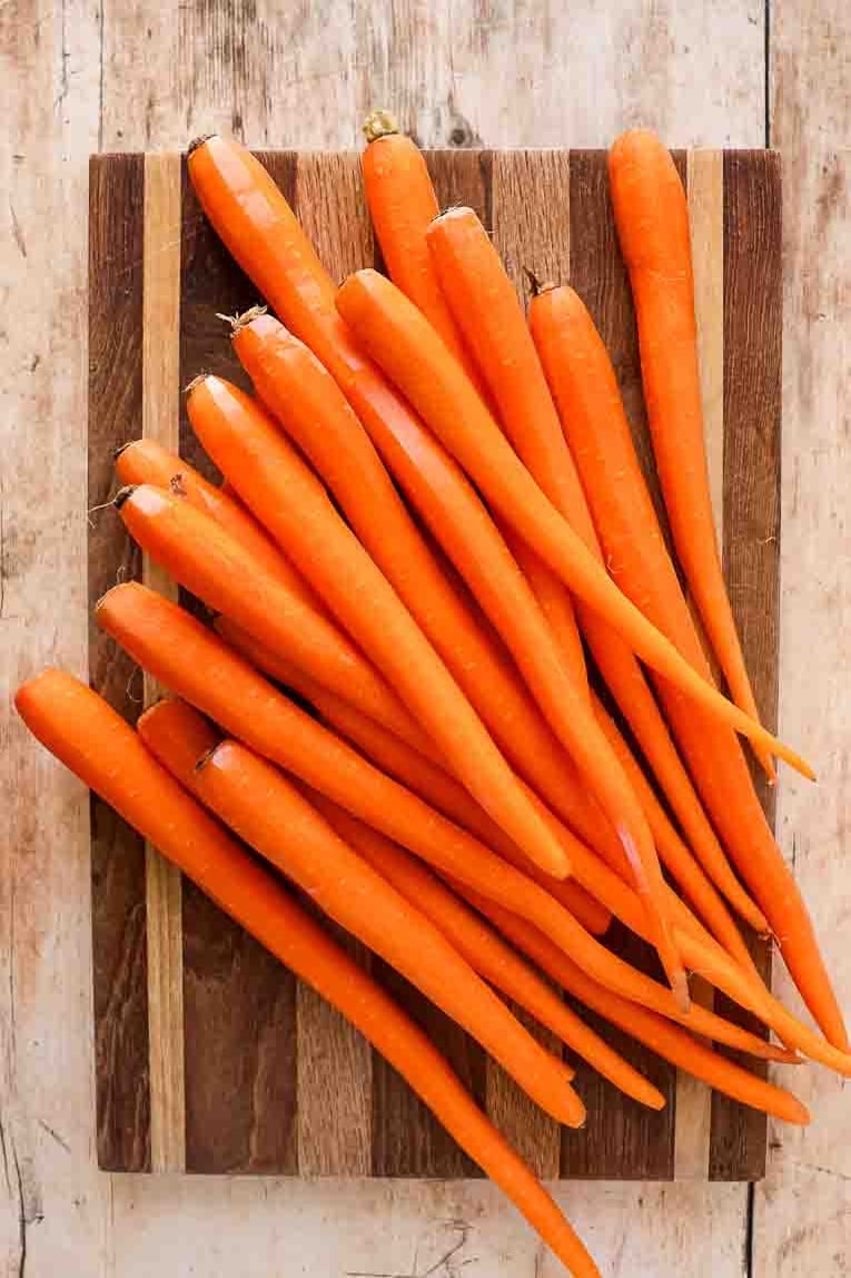 Raw carrots on a cutting board.