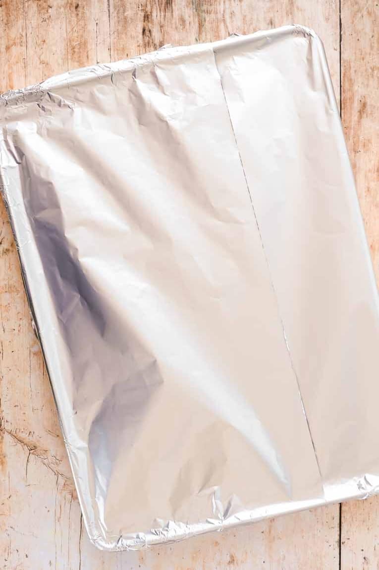 Baking sheet covered with foil for roasting carrots.